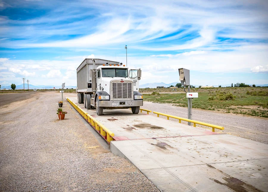 How do truck scales operate and measure the weight of vehicles?